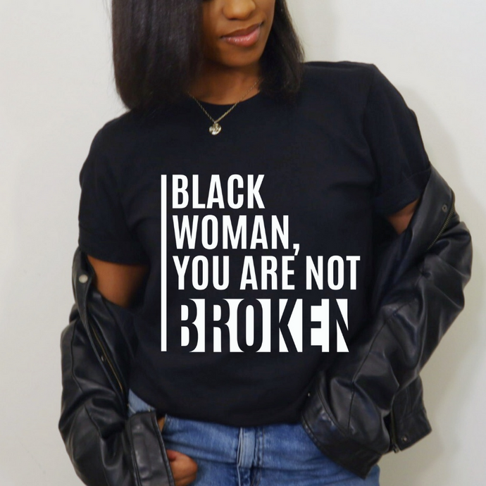 Black woman in black t-shirt with white text
