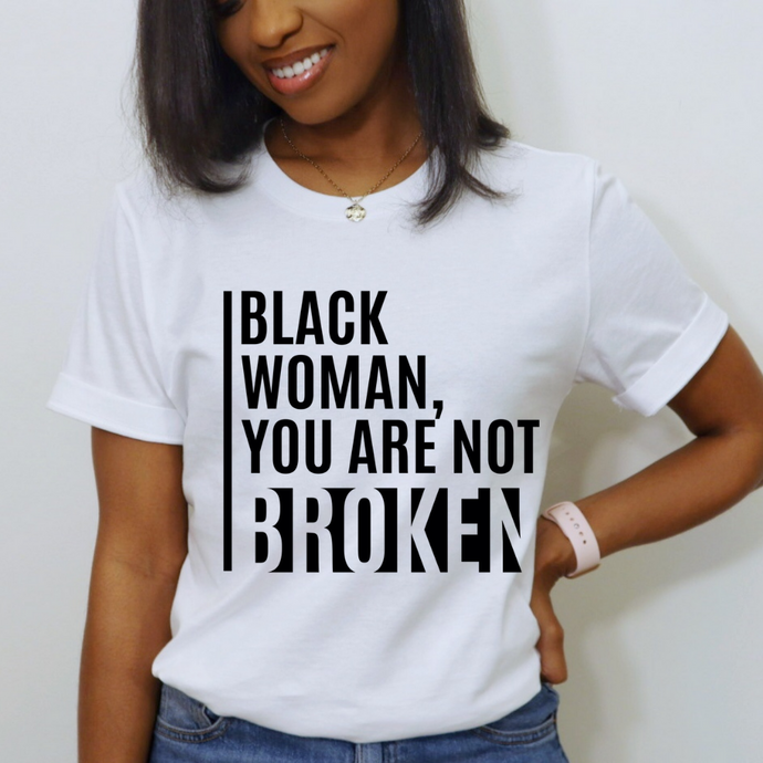 Black woman in white t-shirt with black text